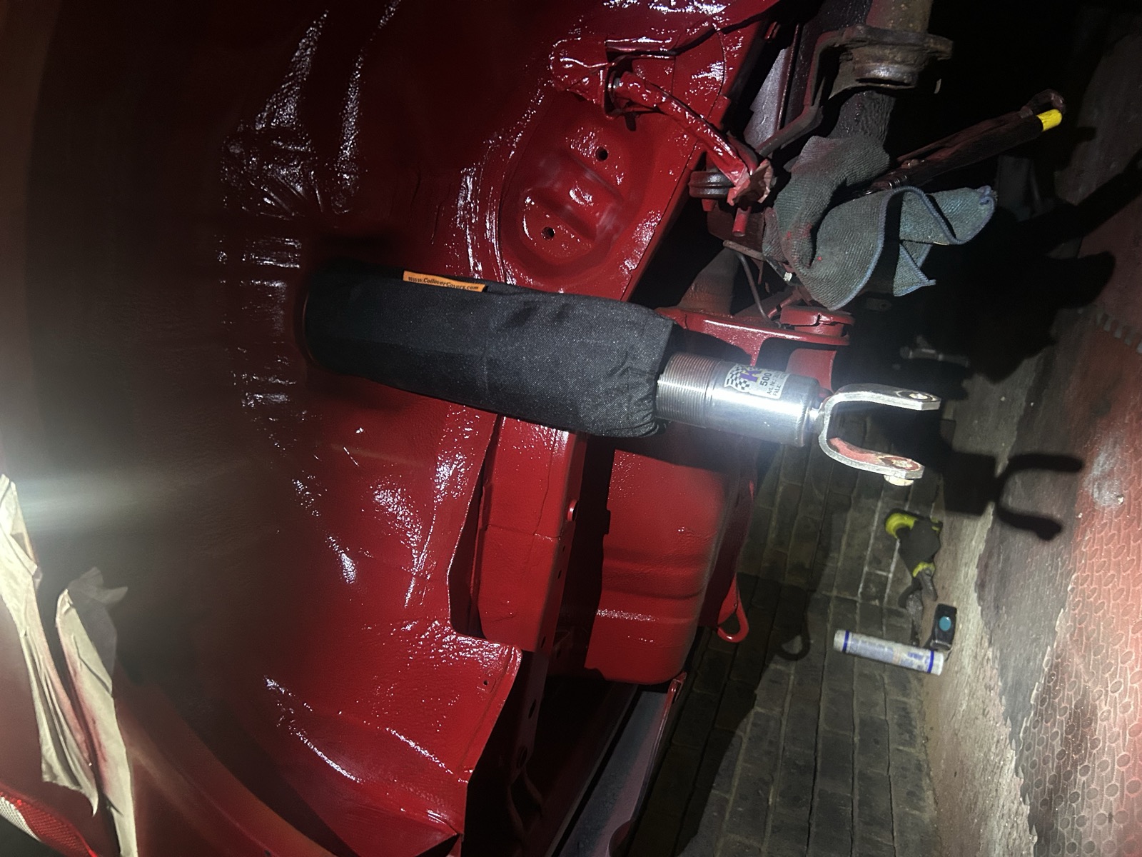 Another underside view of a KW V3 coilover installed with its protective sock