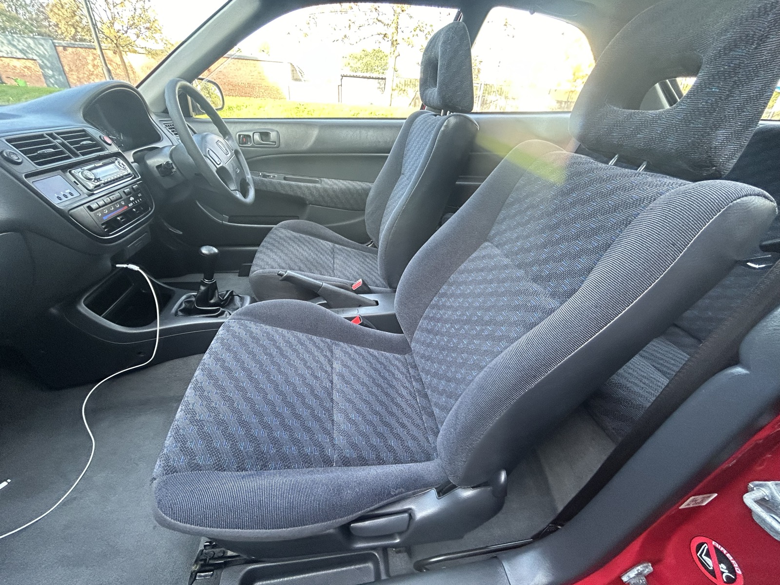 A pair of Mitsubishi Evo 7 bucket seats installed in the front of the Civic EK