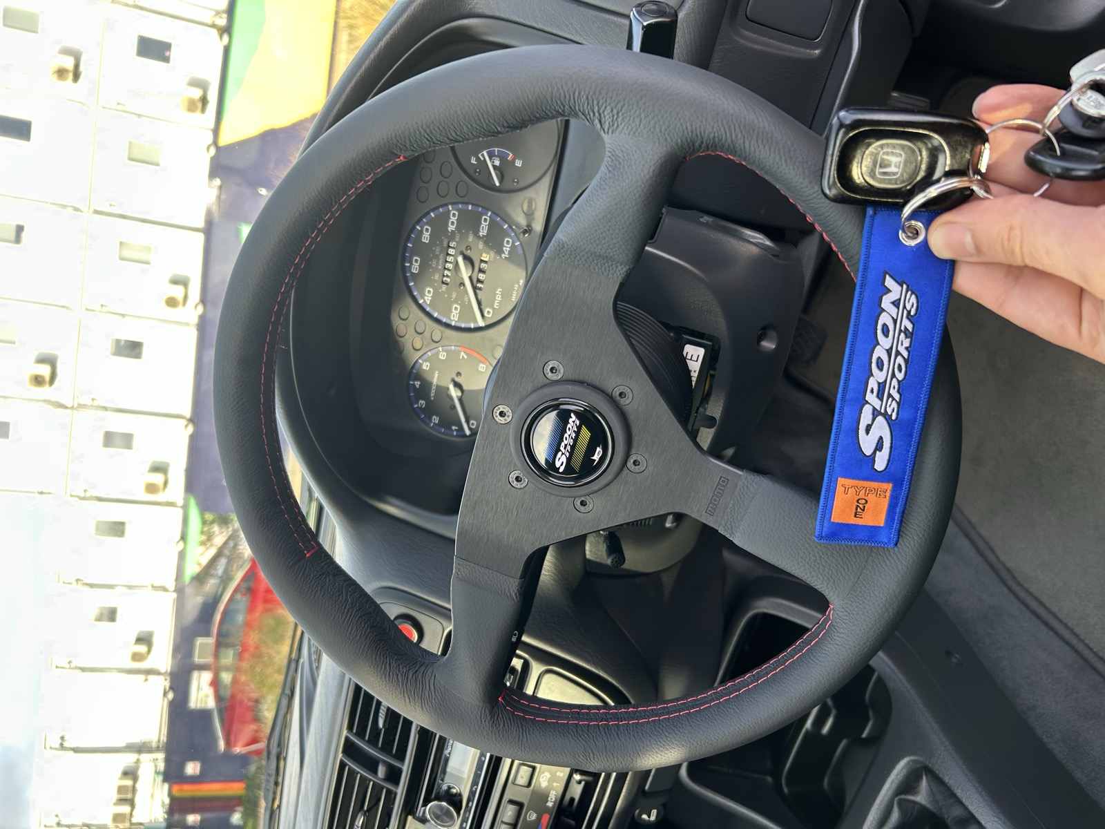 A Spoon Sports steering wheel installed in the Civic EK, viewed from the driver's seat