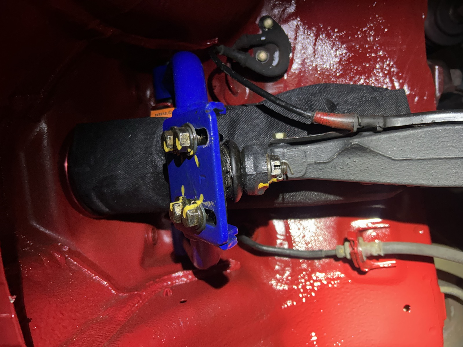 Freshly painted red wheel arch and underside, glossy and clean